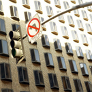 traffic-light-and-wrong-turn-street-sign-against-apartment-building.jpg